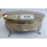 A silver jewellery casket of oval form, the outset hinged lid enclosing a fabric lined interior,