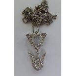 A white coloured gold diamond set, stylised single flower pendant,