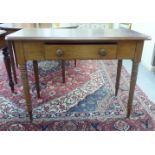 A late 19thC mahogany side table with a central frieze drawer, raised on ring turned,