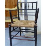 An early 20thC black stained and spindled side chair with a low back,
