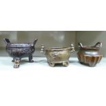 Three dissimilar Oriental cast bronze censers, the bowls with variously fashioned handles 2'' & 2.