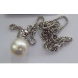 An 18ct white gold mounted, single pearl and diamond set pendant,