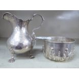 A Victorian silver bulbous cream jug with a C-scrolled handle and engraved decoration,