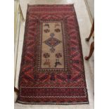 A Persian rug, decorated with repeating stylised designs,