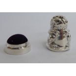 A two-part Sterling silver thimble/pin cushion, fashioned as a rabbit,
