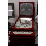 A set of thirteen crushed red velvet framed mirrors with engraved and silvered ornament 15''sq