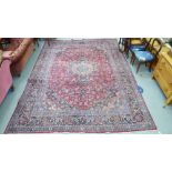A Persian carpet, profusely decorated with stylised floral and foliage designs,
