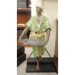 An early 20thC painted iron figure, a standing Persian man wearing a turban and tunic,