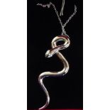 A silver snake pendant,