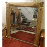 A late Victorian overmantel pier glass, the plate set in a foliate, floral,