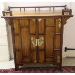 A 20thC Chinese hardwood side table with a low gallery upstand and a pair of doors,