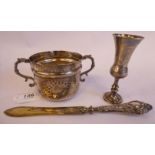 A spot-hammered silver porringer with decoratively cast S-shaped handles 3.