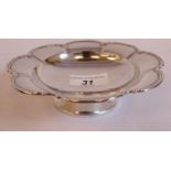 A silver sweet dish with a lobed, applied wire border,