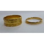 A 22ct gold engraved band ring;