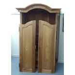 A late 20thC hardwood wardrobe with an arched cornice,