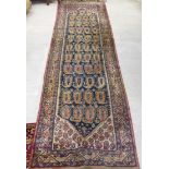 A Persian runner, decorated with twelve columns of arrow head design guls,