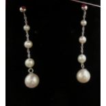 A pair of white gold coloured metal earrings,