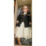 An early 20thC German bisque head doll with mobile composition limbs, wearing traditional costume,