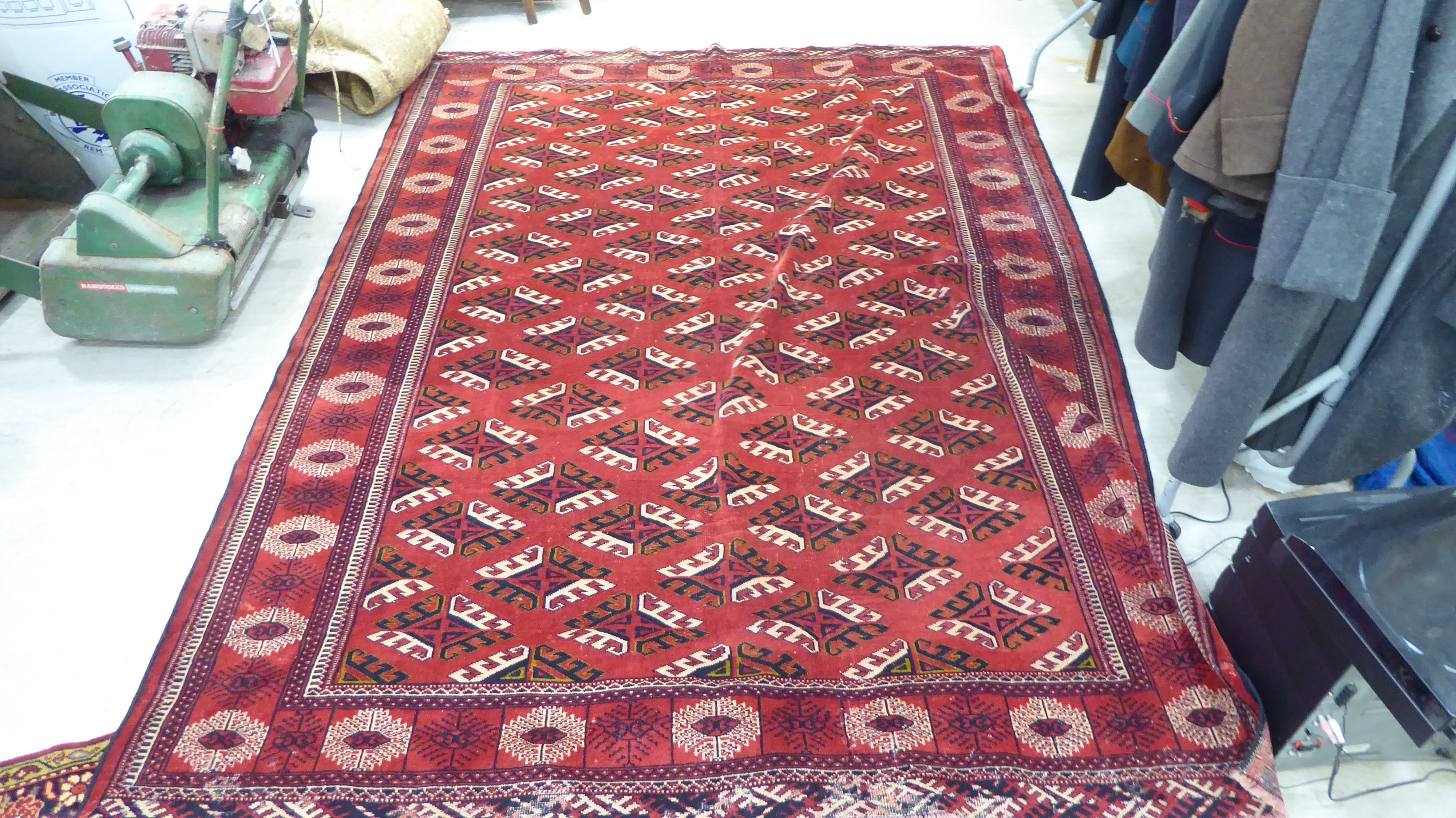 A Turkoman carpet, decorated with repeating stylised designs,