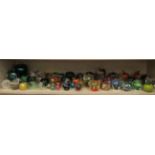 Fifty eight clear and coloured glass apple paperweights various makers,