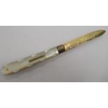 A Victorian silver folding gilt fruit knife with floral and foliate engraved ornament and a