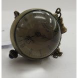 A brass and glass cased miniature ball design timepiece 11