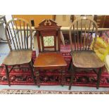 A late Victorian mahogany hall chair with a broken arch pediment crest, over a single,