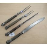 A late Victorian four piece steel carving, set with wooden handles,