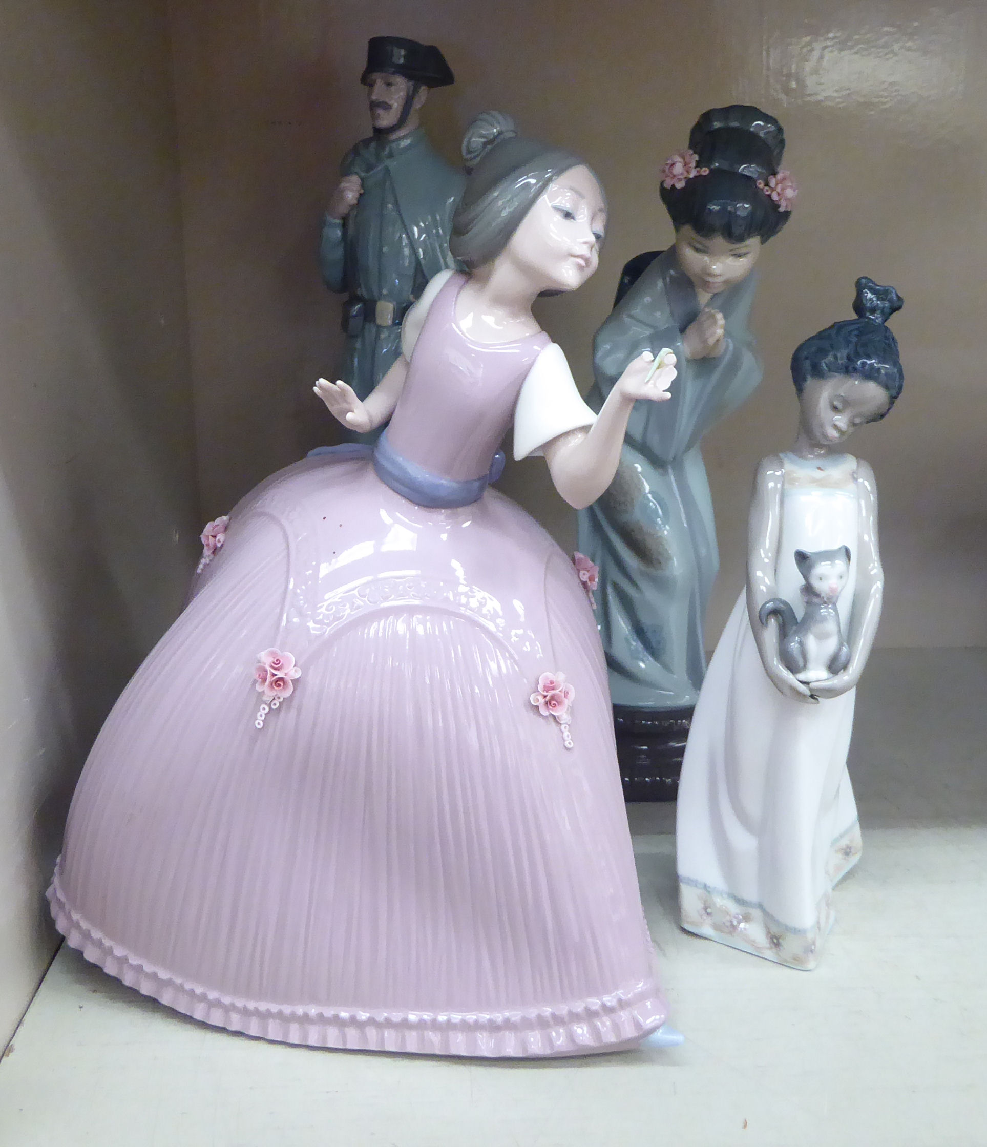 Three Lladro porcelain figures, viz. a Chinese girl wearing traditional costume 10.