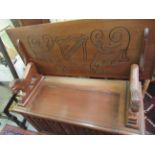 A mid 20thC mahogany monks bench, the naively lion carved arms,