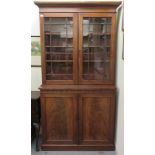 An early Victorian cabinet bookcase, the upper part with a level cornice,