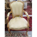 A modern Louis XV design stained beech salon chair with a gold fabric upholstered back and seat,