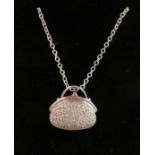 A 14ct white gold diamond set pendant, fashioned as a clutch bag,