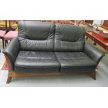 A modern stained and panelled oak two person settee,