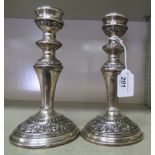 A pair of silver candlesticks,