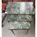 A mid 20thC nesting set of three Italianate occasional tables with faux marble tops,