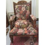 A late Victorian walnut framed salon chair with a floral tapestry upholstered back and seat,