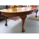 A 1920s mahogany wind-out dining table,
