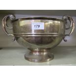 A silver trophy bowl with opposing, outset scrolled handles,