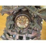 A 20thC Bavarian inspired carved beech cuckoo clock;