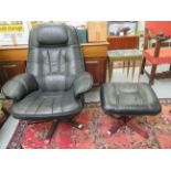 A modern cushioned and stitched soft black hide upholstered recliner armchair,