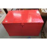 An early 20thC and later pillar box red painted hardwood trunk with iron re-enforcement,