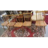 A set of five Ercol beech and elm framed spindled back kitchen chairs with level bar crests and