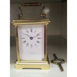 A mid 20thC Friend lacquered brass cased carriage timepiece, having a folding top handle,