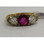 A yellow metal ring, set with a central ruby,