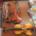 Three student/child's violins, one with a shanghai,