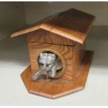 A novelty money box, fashioned in light oak,