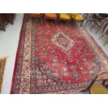 A Persian rug, profusely decorated with floral and foliate ornament,