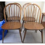 A set of four Ercol stained beech and elm framed hoop and spindled back dining chairs,