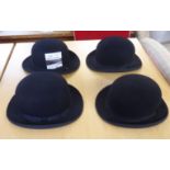 Four similar black bowler hats, viz. G A Dunn & Co size 7.